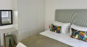 a small bedroom with a bed and a desk at Fisherman's Rest in Paternoster
