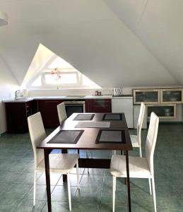 a kitchen with a table and chairs and a window at „Sėlių Studio“ Apartamentai in Utena +23 photos
