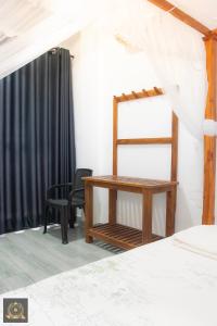 a bedroom with a desk and a chair at Triple W in Watta
