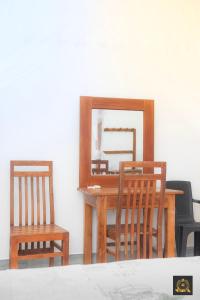 a wooden table with a mirror and two chairs at Triple W in Watta
