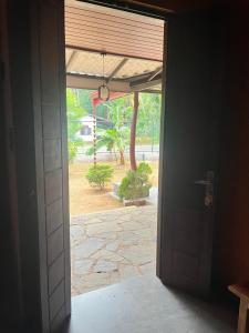 an open door with a view of a courtyard at Triple W in Watta