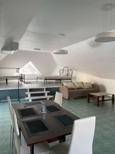 a living room with a table and a couch at „Sėlių Studio“ Apartamentai in Utena