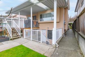 a house with a balcony and a stairway at Central Van 1bedroom Suite in Vancouver