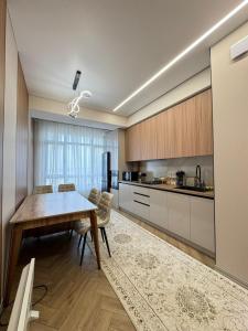 a kitchen with a table and a dining room at Eleon apartment in Bishkek