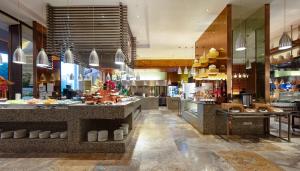 a restaurant with a buffet line in a building at Four Points by Sheraton Taicang in Taicang