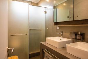 a bathroom with a sink and a shower at ELYMUS - Spacious 3-Bedroom Apartment With Private Rooftop and Balcony - Near Le Morne And Lagoon in La Gaulette