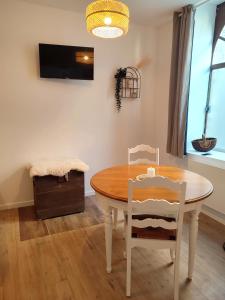 a dining room with a table and two chairs at Le Bohème in Chaumont