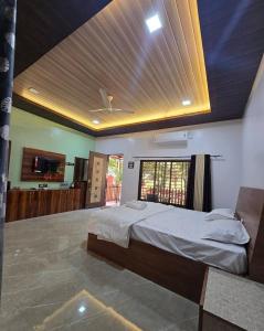 a bedroom with a large bed with a ceiling at Private Beach - Exotic Sea View Resort in Ganpatipule +17 photos