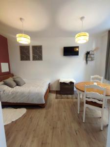 a bedroom with a bed and a dining room table at Le Bohème in Chaumont +13 photos