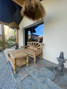 a patio with a bench and a large window at Domaine Coul'Eau in Eaunes