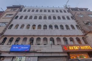 an old building sitting on the side of a street at Avtar new delhi railway station in New Delhi