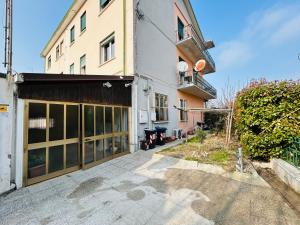 an external view of a building with a garage at Terme Boutique House in Montegrotto Terme