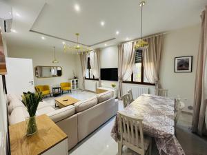 a living room with a couch and a table at Terme Boutique House in Montegrotto Terme
