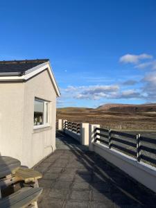a building with a balcony with a view of the desert at The Homer in Kilmuir