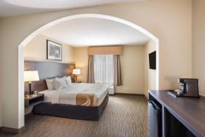 a hotel room with a bed and a window at Quality Inn & Suites Fishkill South near I-84 in Fishkill