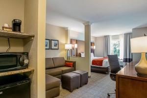 a hotel room with a couch and a bed at Comfort Suites Fishkill near Interstate 84 in Fishkill
