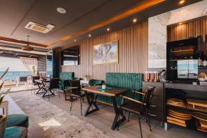 a restaurant with chairs and tables and a bar at Padam Hotel & SPA in Ulcinj
