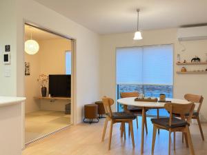 a dining room with a table and chairs at The ITO 伊藤 in Abiko