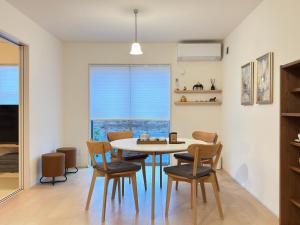 a dining room with a table and chairs at The ITO 伊藤 in Abiko