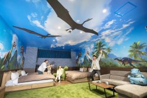 a childrens room with a dinosaur mural at Ooedo Onsen Monogatari Premium Seiunkaku in Awara