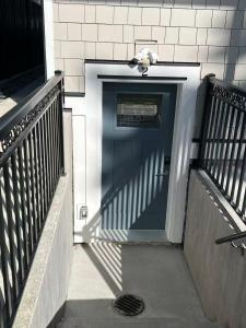 a blue door with a bird sitting on top of it at Modern Vancouver 2BR Suite Full Kitchen & Laundry in Vancouver +4 photos
