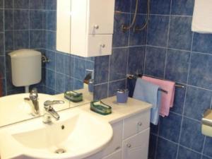 a bathroom with a sink and a mirror at Apartments Eden in Jadranovo
