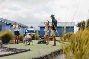a group of people playing golf in a yard at Tasman Holiday Parks - Miranda in Miranda