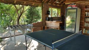 a ping pong table in a room with a kitchen at El Caserio Casas de Campo in Villa Cura Brochero