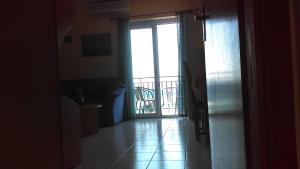 a hallway with a door open to a balcony at Apartment Sunce in Crikvenica