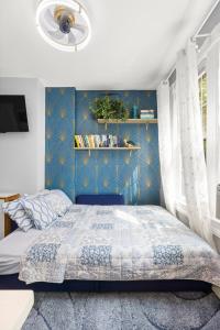 a bedroom with a bed with a blue wall at Bright 2BR Retreat Walk to PATH NYC Access in Jersey City +16 photos