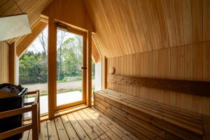 an empty room with a window in a wooden cabin at ERUSA Rusutsu in Rusutsu
