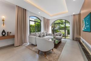 a living room with a couch and a table at Costamigo Phan Thiet, BW Premier Collection in Phan Thiet