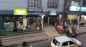 a white car is parked in front of a store at Fanai Inn in Āīzawl