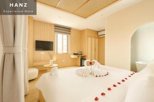 a bedroom with a bed with two swans on it at HANZ Lagoon Sunset Hotel in Phú Quốc