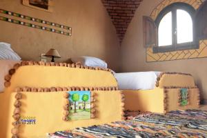 Voodi või voodid majutusasutuse Qasr El Bagawat Hotel toas