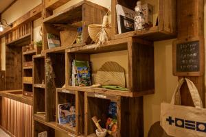 a library with wooden shelves with books at HOTEL tuka miika in Ishigaki Island