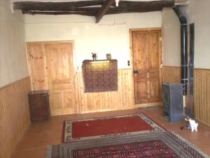 a living room with wooden walls and a room with a rug at Rural Horizons on La Ruta del Cister in Forés