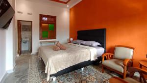 a bedroom with a bed and a chair at Sabi Studio in Timuran