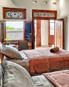 a bedroom with two beds and a window at Sabi Studio in Timuran +59 photos