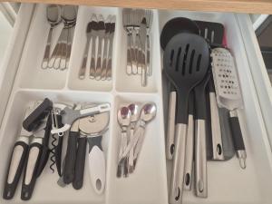a drawer filled with lots of kitchen utensils at le st fursy 1 in Péronne