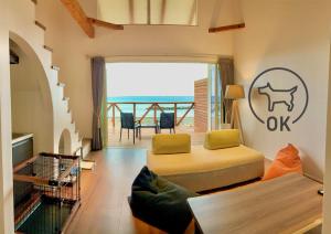 a living room with a bed and a balcony at Love&Peace Resort in Shima
