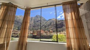 a window with a view of mountains at Amazing views PISAQ in Pisac