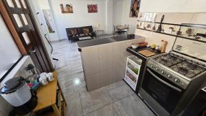 a kitchen with a stove and an open refrigerator at Amazing views PISAQ in Pisac