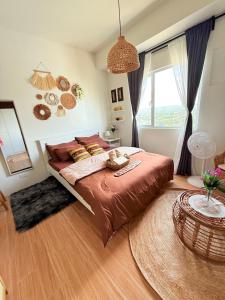 a bedroom with a large bed and a large window at Baan Mai Condo Staycation in Biñan +44 photos