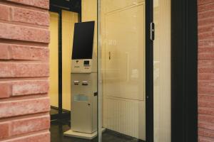 a television in a glass door next to a wall at Hotel Solide Cheonan in Cheonan