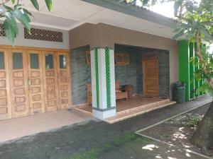 a house with wooden doors and a porch at Hamemayu Homestay in Jejeran +3 photos