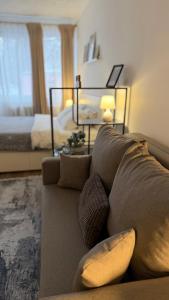 a living room with a couch and a bed at Church Hill Apartment in Daugavpils