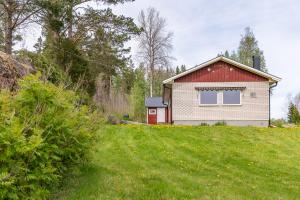 a house on top of a grassy hill at Lagom huset in Årjäng +2 photos