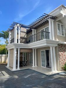 a large house with a balcony on top of it at Solmera Villa in Grand-Baie
