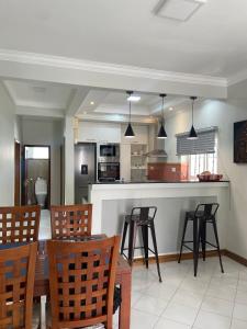 a kitchen and dining room with a table and chairs at Solmera Villa in Grand-Baie
